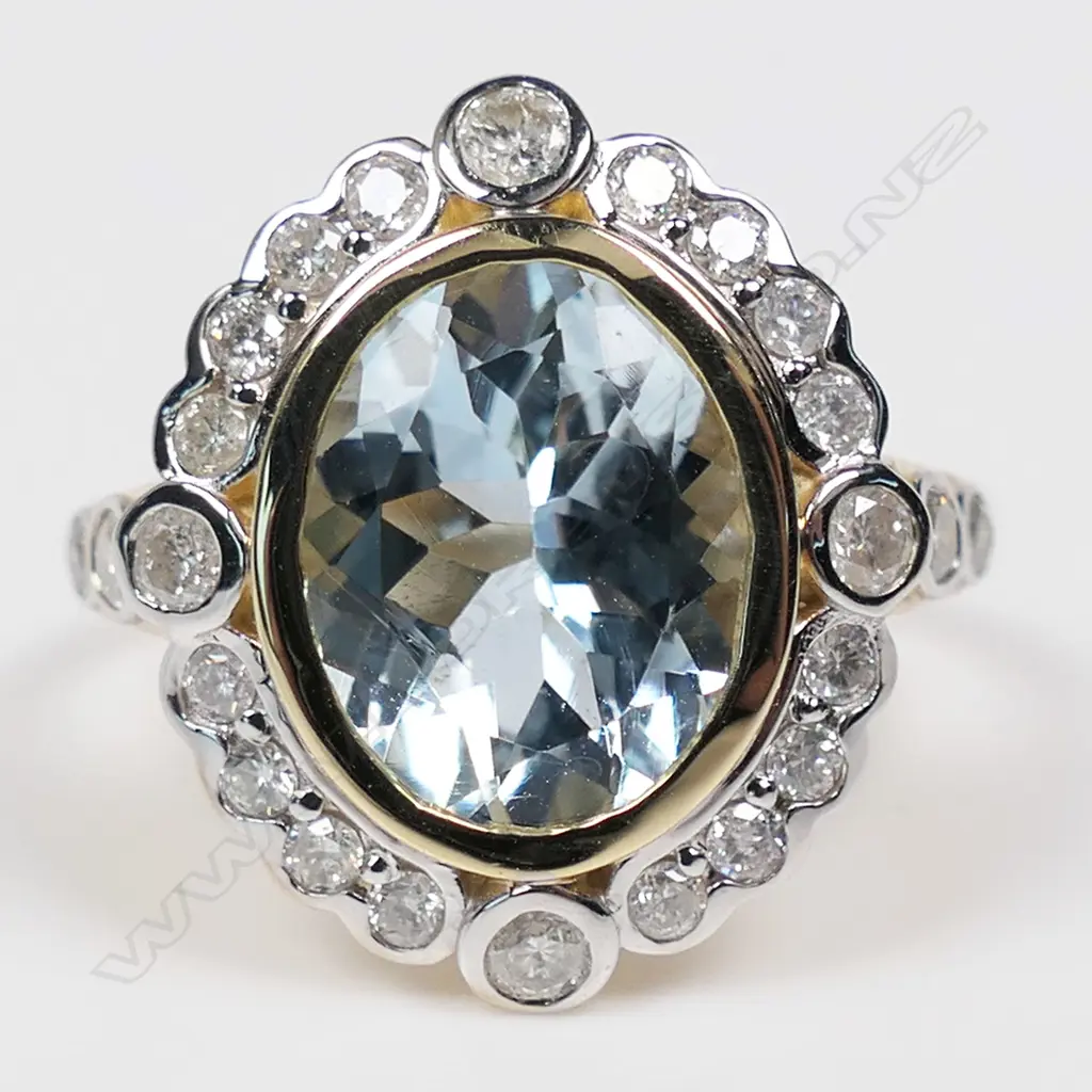 A 14ct gold aquamarine and diamond halo ring, Image 1++