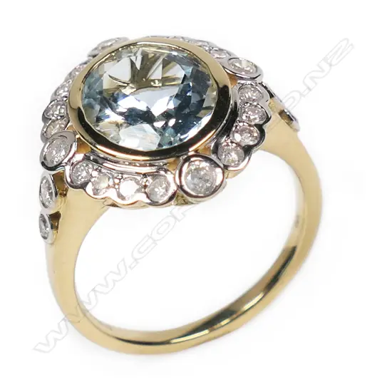 A 14ct gold aquamarine and diamond halo ring,