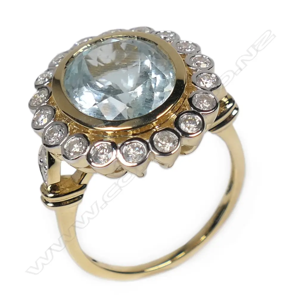 A 14ct gold aquamarine and diamond halo ring, Image 1++