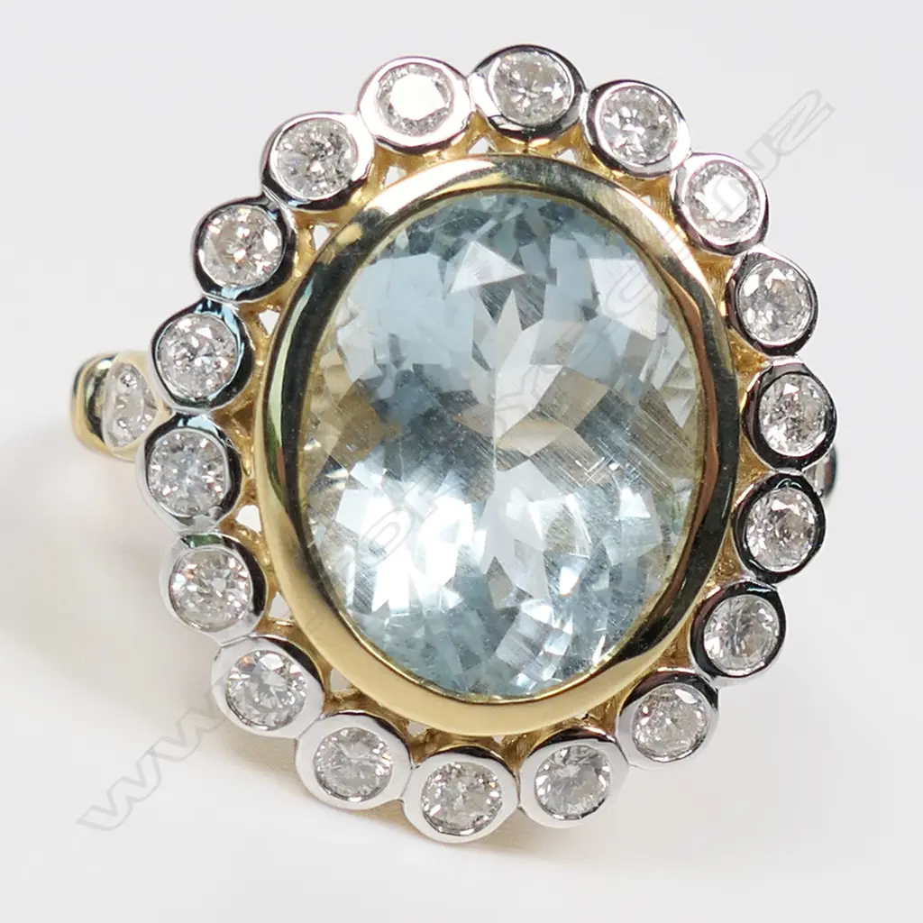 A 14ct gold aquamarine and diamond halo ring, Image 1++