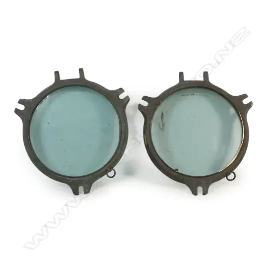 A pair of John Roby Ltd. vintage brass and glazed porthole covers,