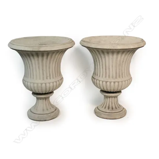 A pair of classical concrete garden pedestal urns,