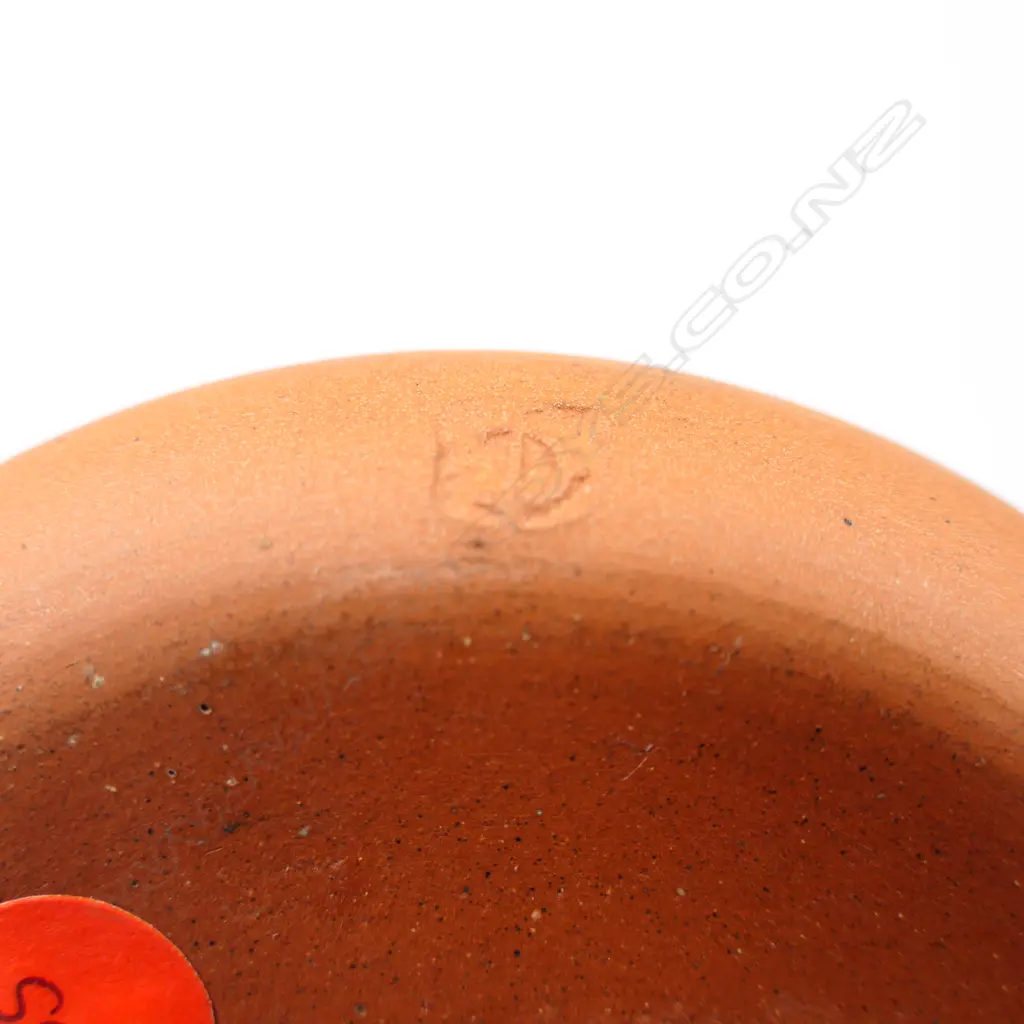 Len Castle ‘pin dish”  with a blue glaze inside with three stylised leaping human figures in white glaze. Red-brown coloured clay body. Stamped mark near the base. Dia.105mm. Image 1++