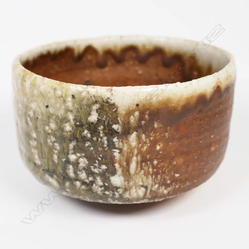 Bruce Martin (-2023) anagama Tea Bowl. Japanese 'shino' style with pale green over-glaze. Maker's mark to base. H.120mm. Image 1++
