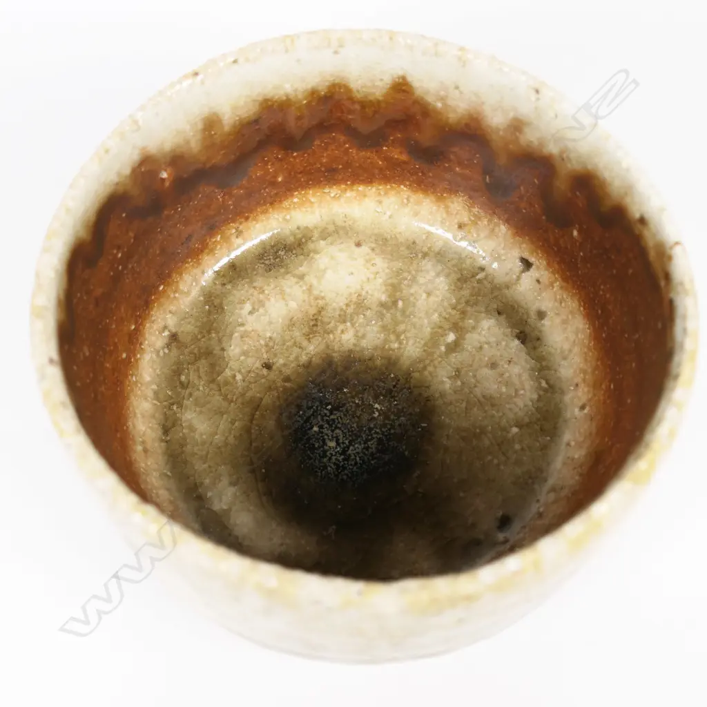 Bruce Martin (-2023) anagama Tea Bowl. Japanese 'shino' style with pale green over-glaze. Maker's mark to base. H.120mm. Image 1++
