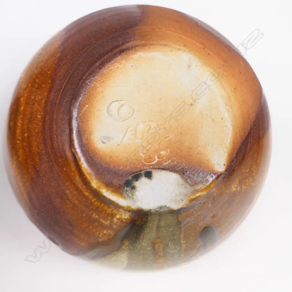 Estelle Martin anagama ovid vase with single lug on shoulder. Green & brown glazes. Mark to base. H 140mm. Image 1++