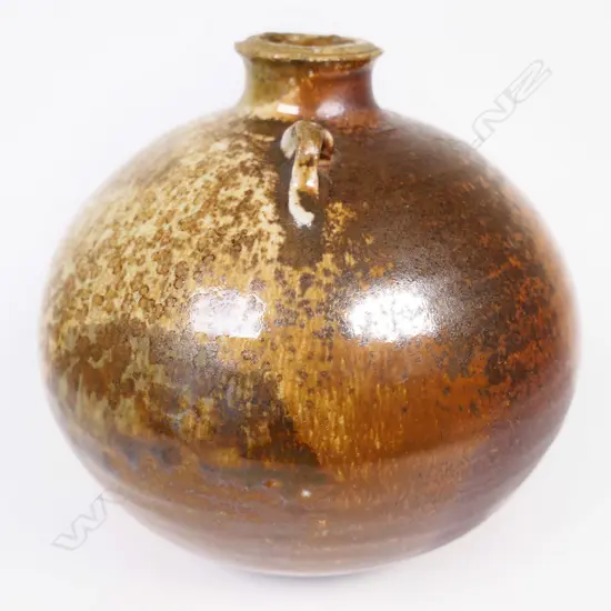 Estelle Martin anagama ovid vase with single lug on shoulder. Green & brown glazes. Mark to base. H 140mm.