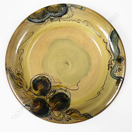 John Anderson lrg 1970s charger, ocre glaze w floral swirls, signed to base, Dia.340mm