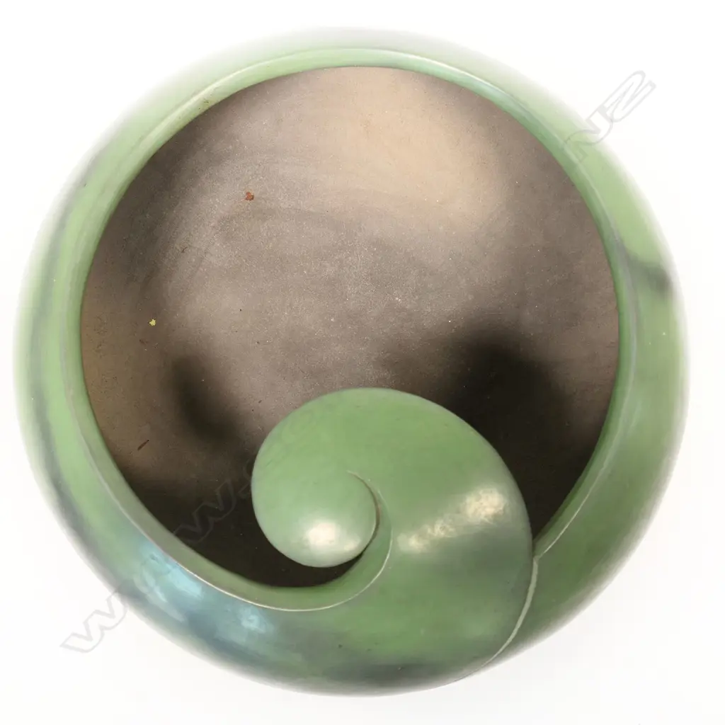 A rare Robyn Stewart (1938-2018) large jade green koro form bowl. Dia.400mm. Dung fired raku, jade green burnished with matte finish; the rim modelled in a Koru design Image 1++