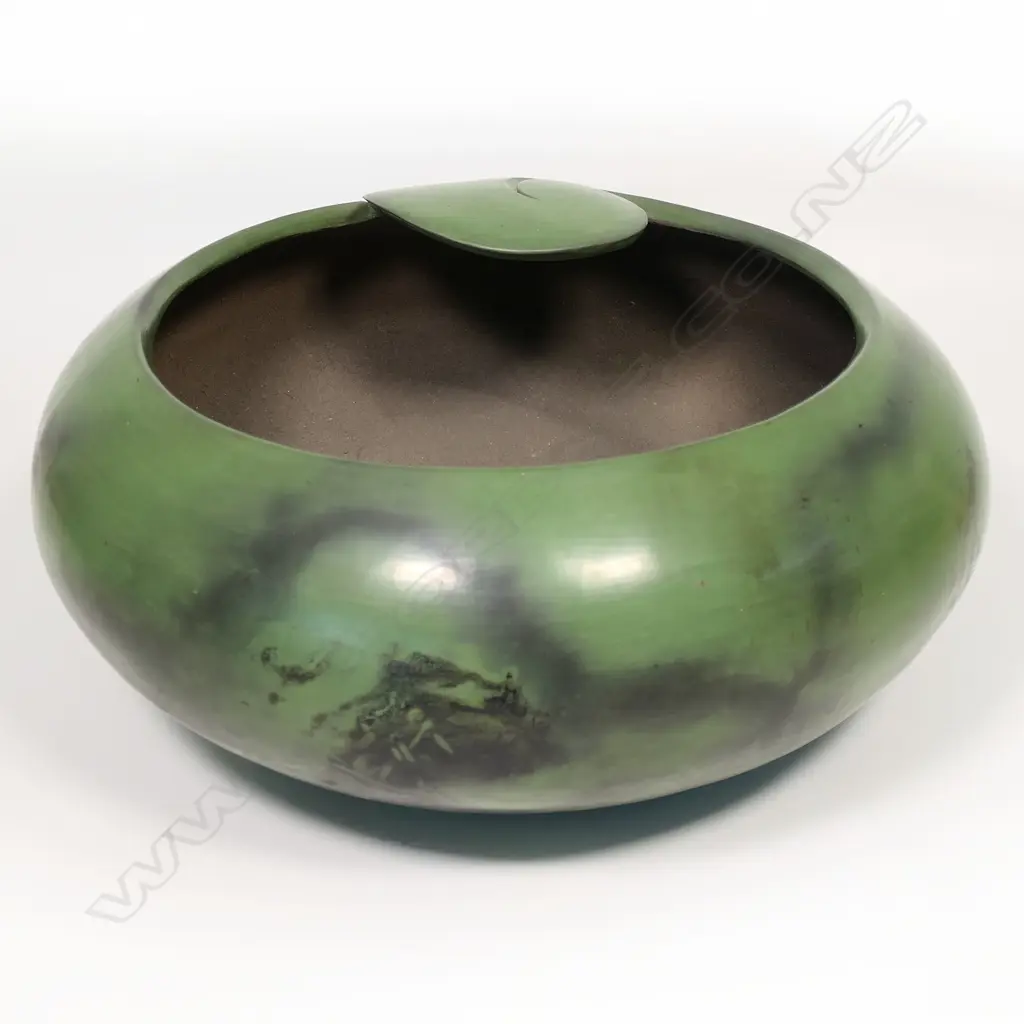 A rare Robyn Stewart (1938-2018) large jade green koro form bowl. Dia.400mm. Dung fired raku, jade green burnished with matte finish; the rim modelled in a Koru design Image 1++