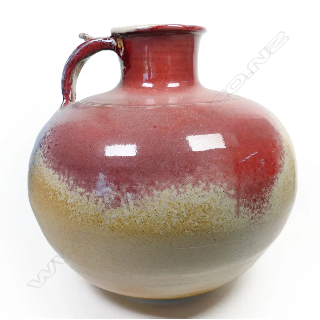 (F20A) Murray Garner red copper glazed floor standing vessel w handle. H 370mm. Image 1++