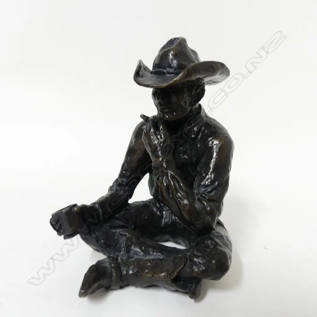 A small original bronze figure of a seated cowboy Image 1++