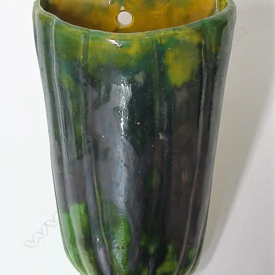 A large Briar Gardner wall pocket vase glazed in emerald green
