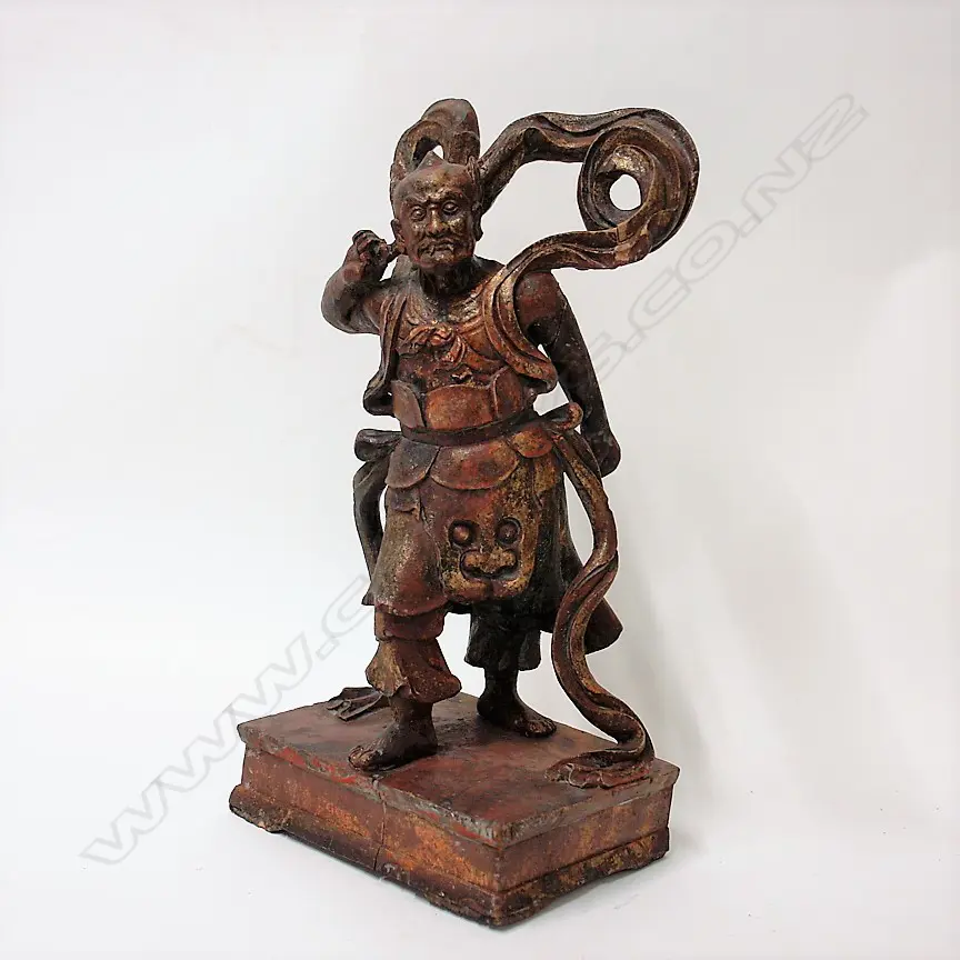 A Chinese carved wood lacquered and gilded figure of a demon Image 1++