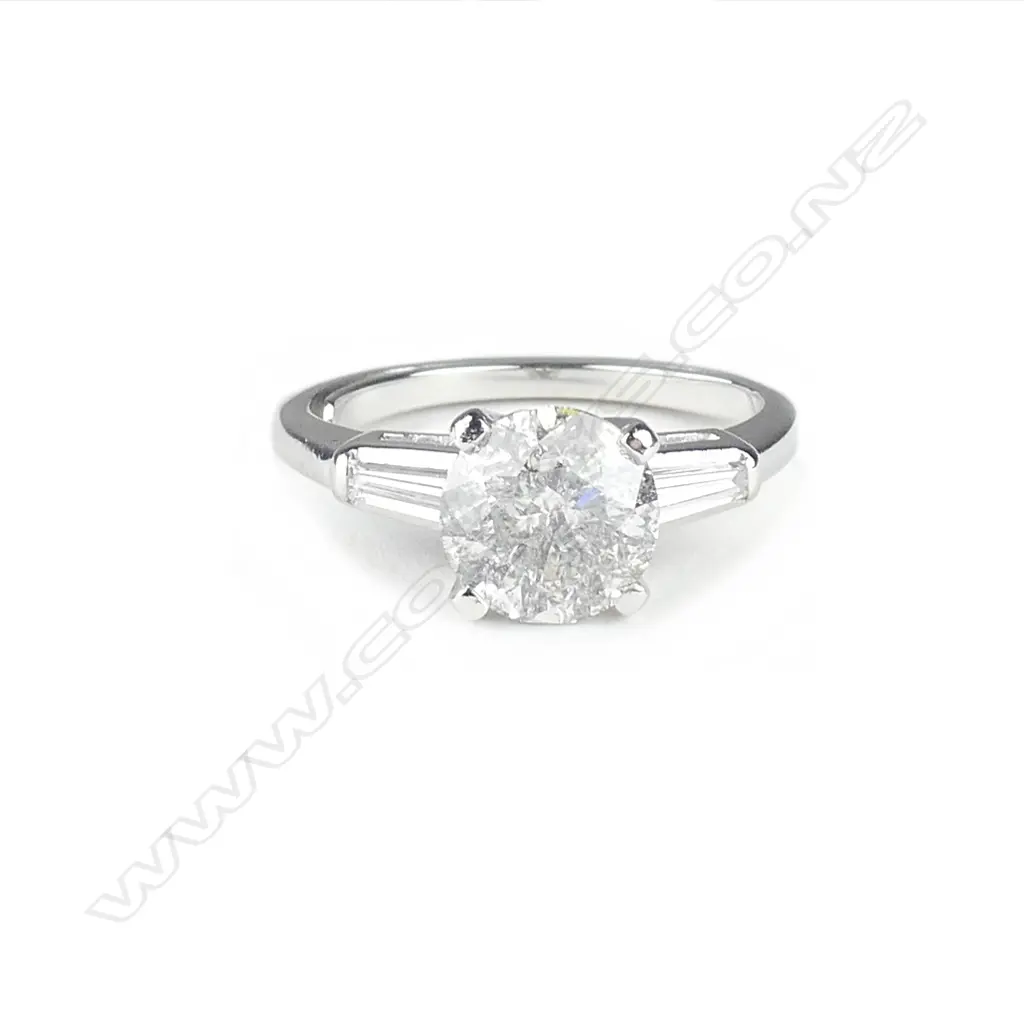 A platinum and diamond solitaire ring Image 1++