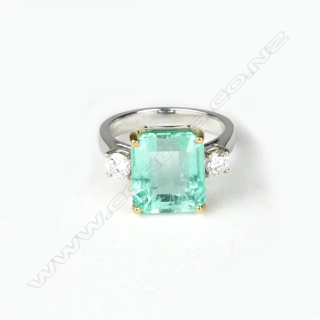 A good modern 18ct. yellow and white gold emerald and diamond dress ring Image 1++