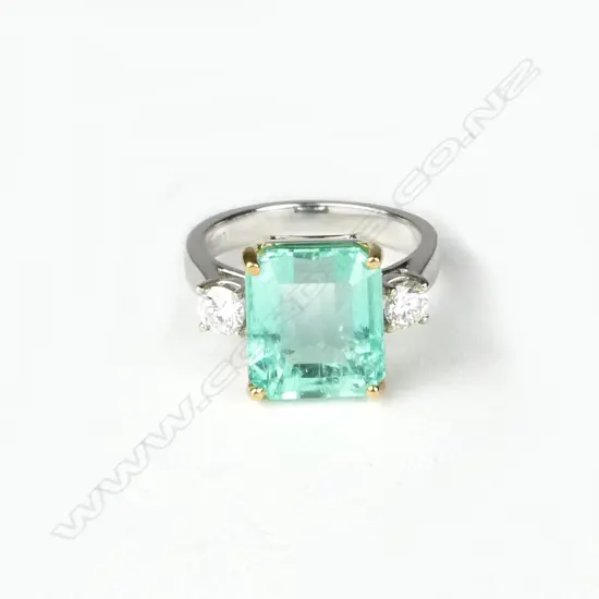 A good modern 18ct. yellow and white gold emerald and diamond dress ring