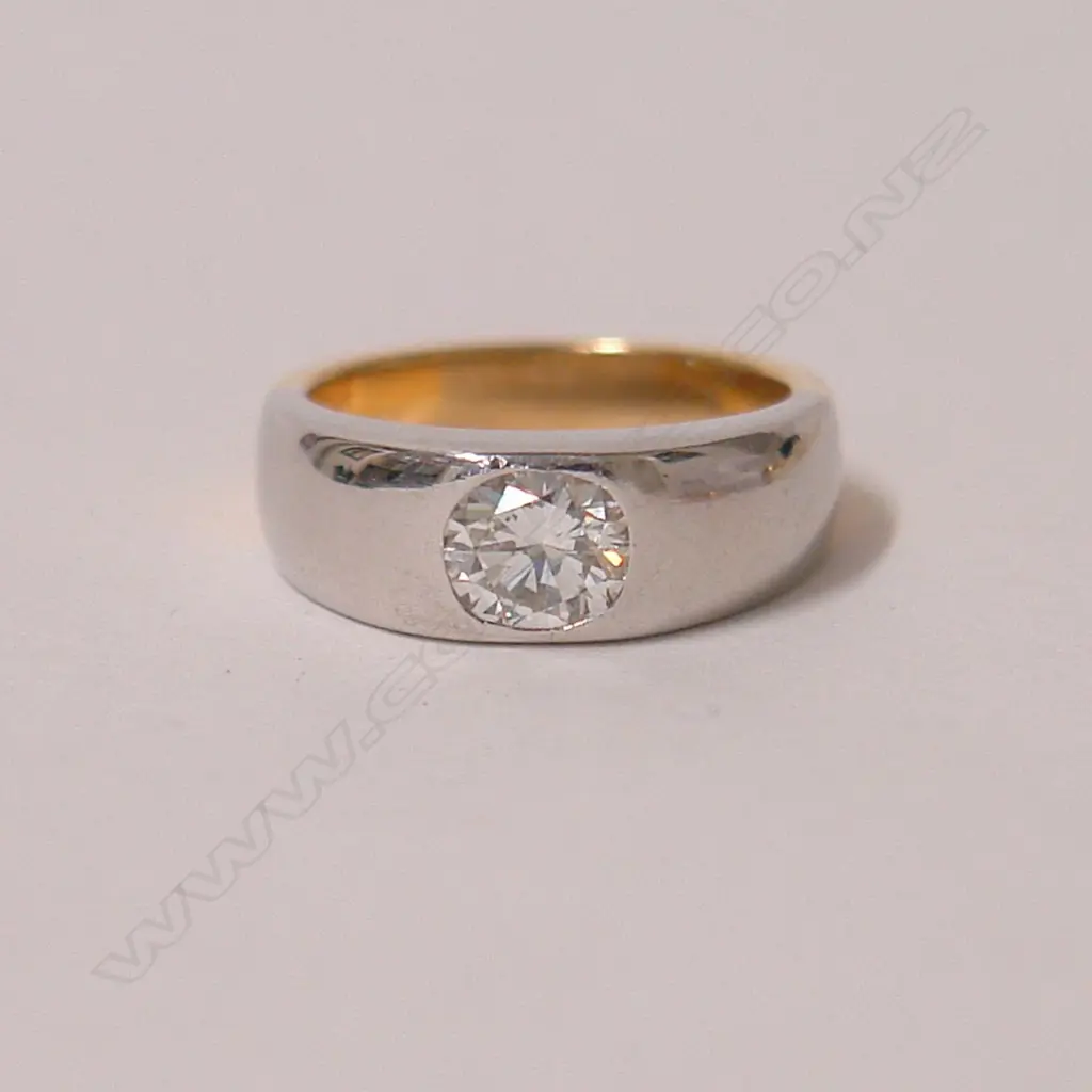 A modern 18ct. yellow and white gold solitaire diamond ring Image 1++