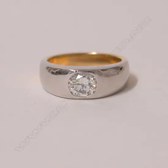 A modern 18ct. yellow and white gold solitaire diamond ring