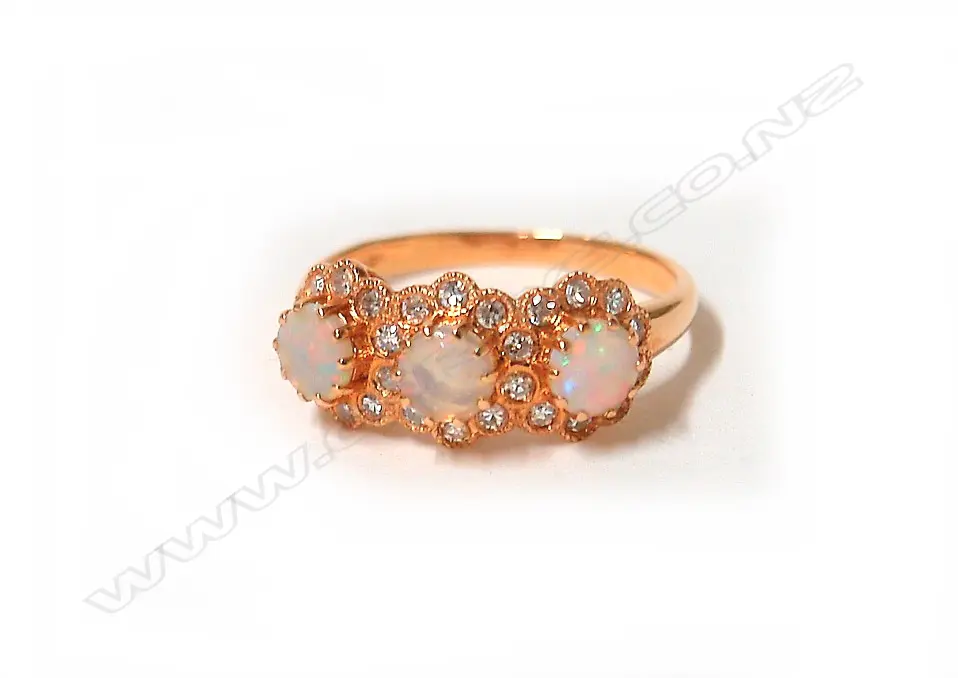 A modern 18ct. rose gold opal and diamond three-cluster ring Image 1++