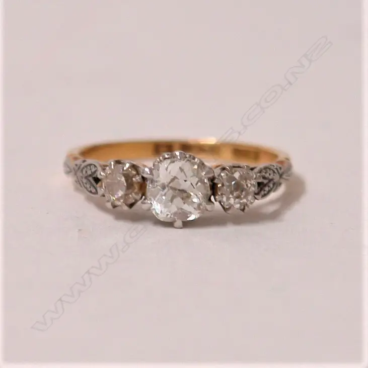 A lady's estate 18ct. yellow and white gold three stone diamond ring Image 1++