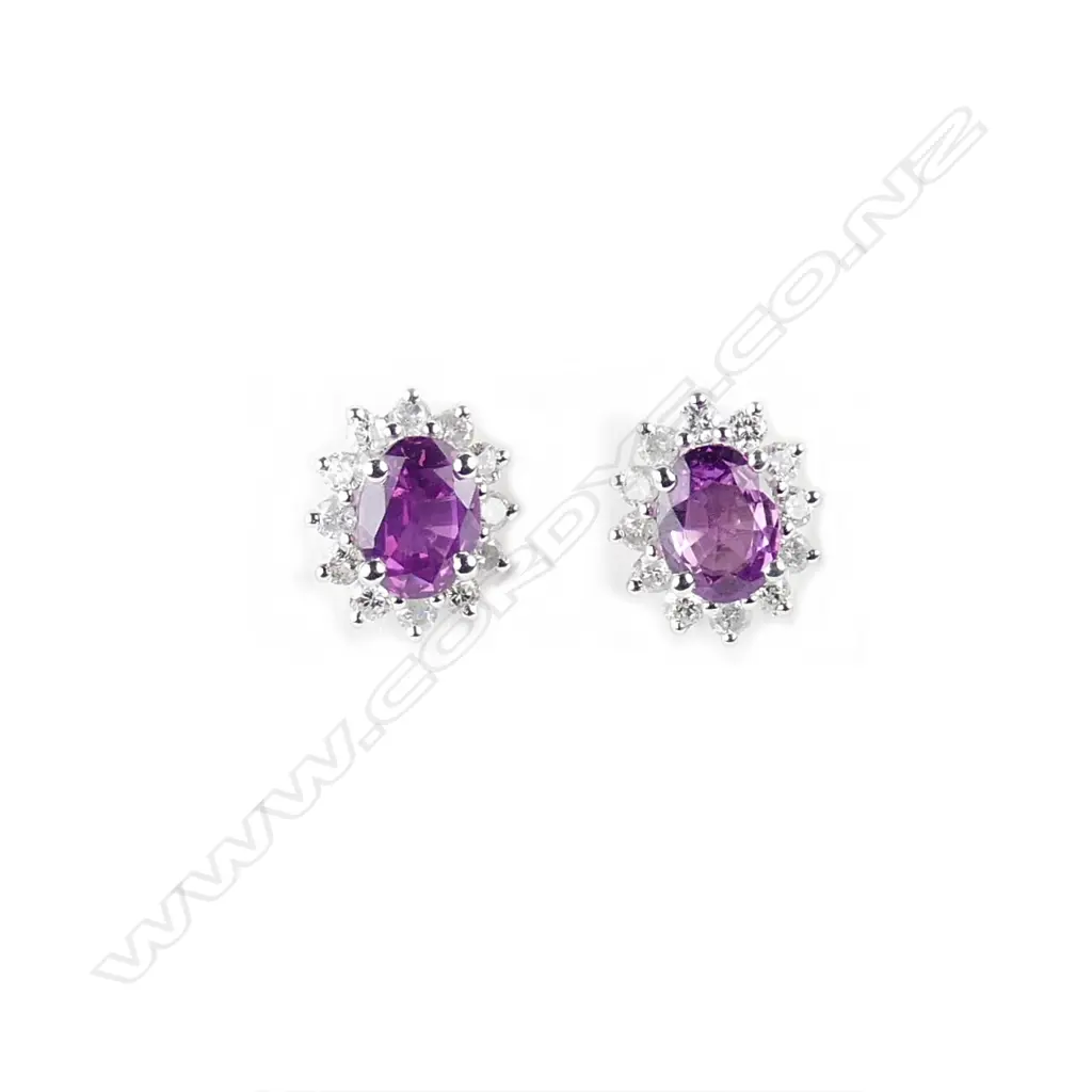 A pair of 14ct. white gold sapphire and diamond stud earrings Image 1++