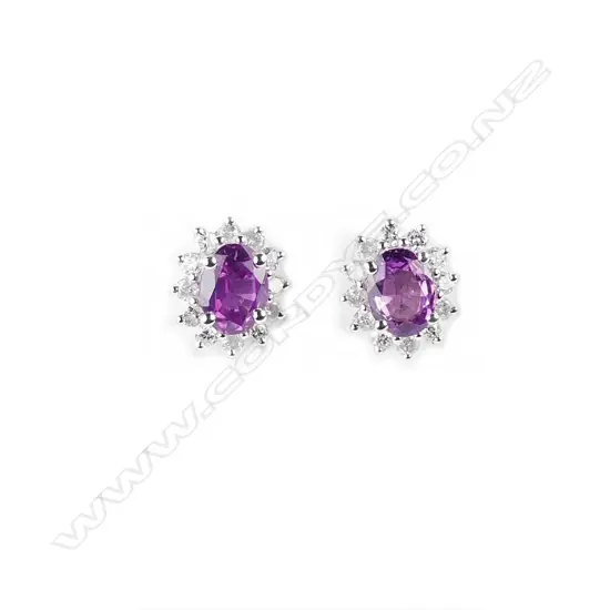 A pair of 14ct. white gold sapphire and diamond stud earrings
