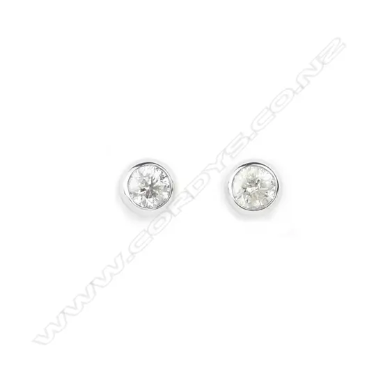 A pair of 14ct. white gold diamond stud earrings