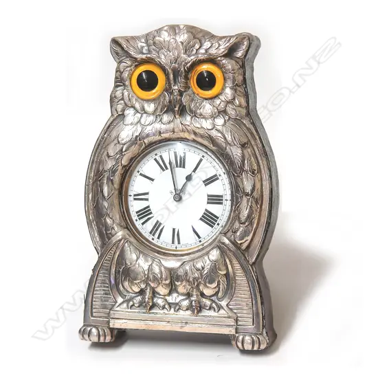 An early 20thC silver plate owl pocket watch stand