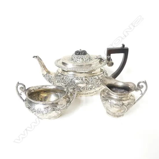 An Edwardian period ornately embossed silver three-piece tea set