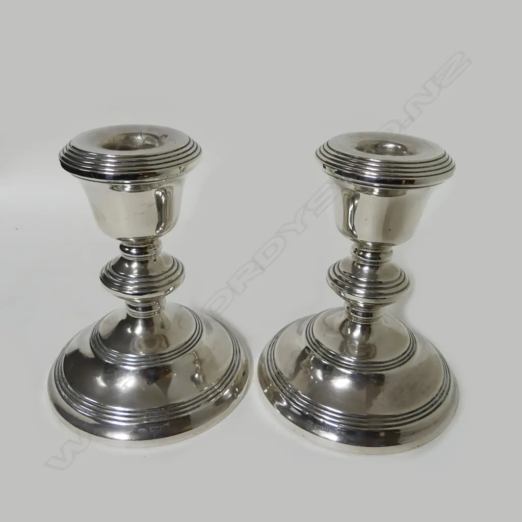 A pair of small silver candlesticks Image 1++