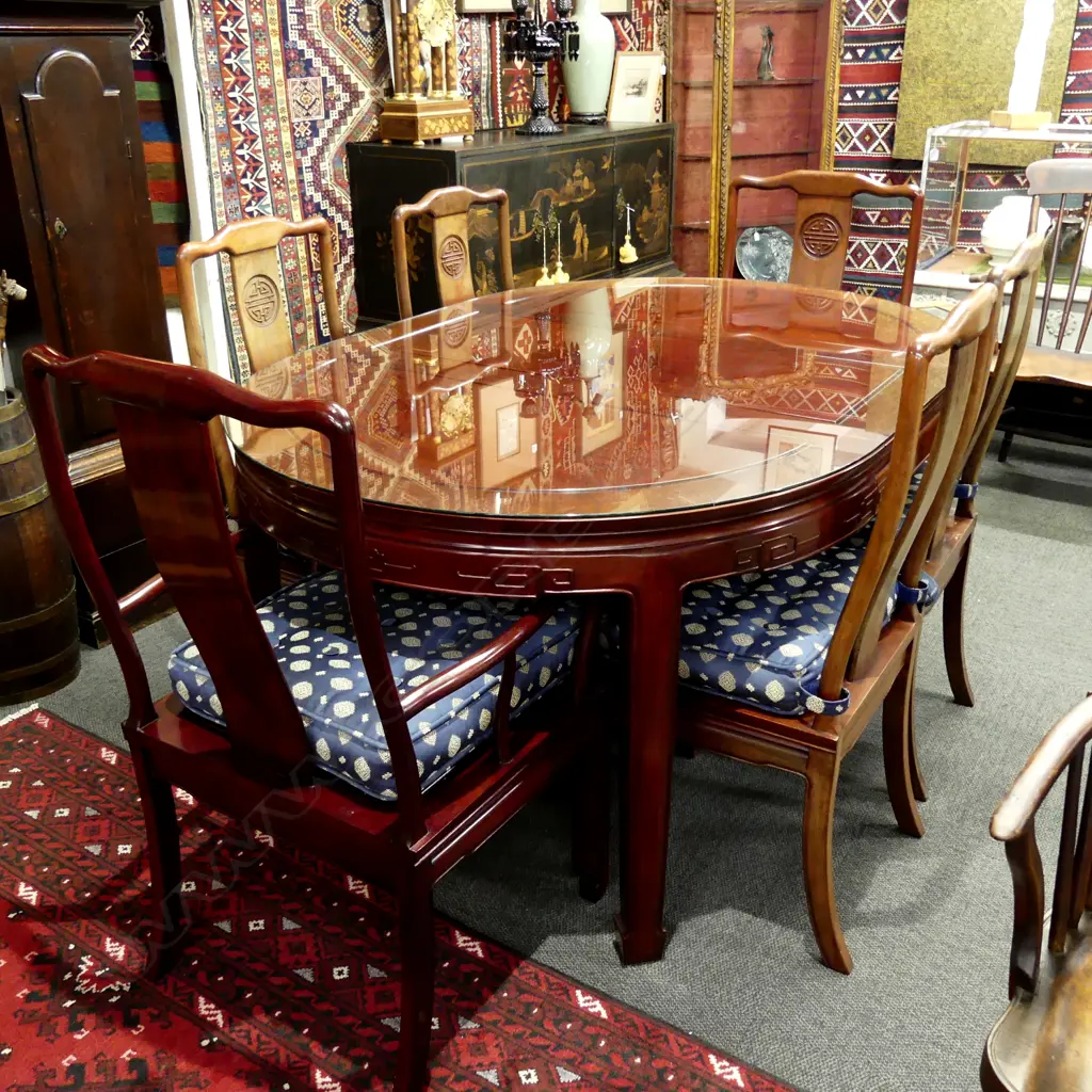 A Chinese rosewood dining table and six chairs Image 1++