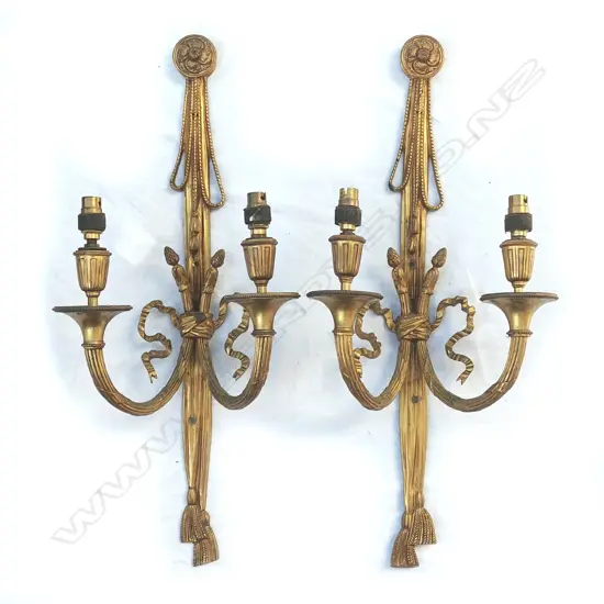 A pair of cast brass twin light wall brackets of French style