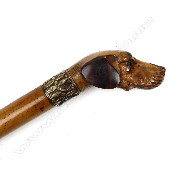 A dog head carved malacca cane walking stick