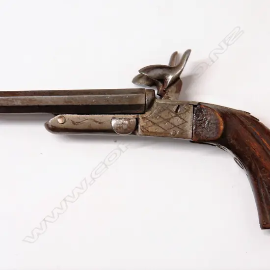 An antique .32cal double barrel pocket pistol