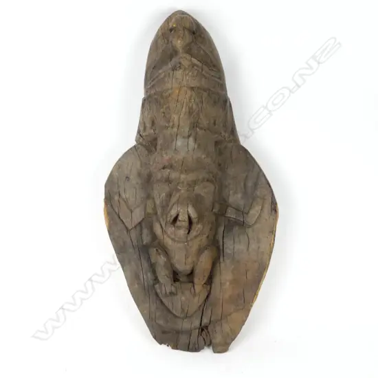 A carved wood house totem