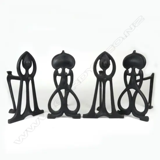 Two pairs of Art Nouveau cast iron fire dogs