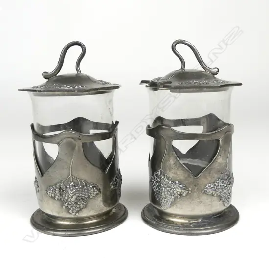 A pair of Orovit pewter and glass condiment pots