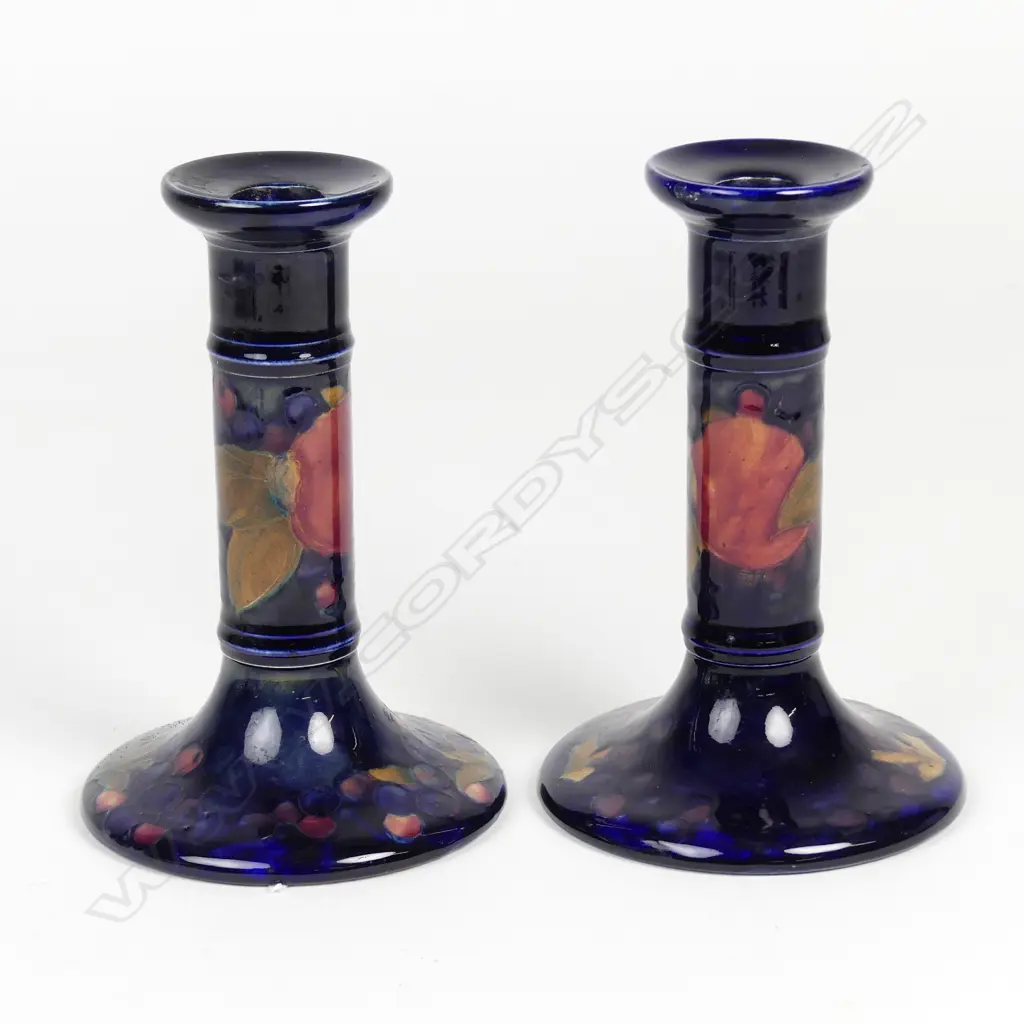 A pair of William Moorcroft pomegranate decorated candlesticks Image 1++