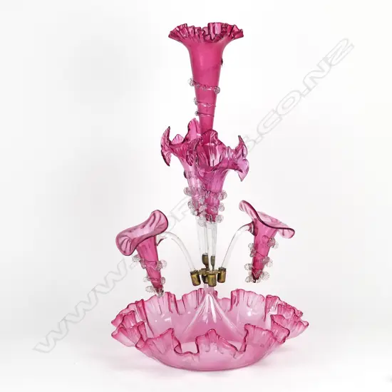 A Victorian cranberry glass five trumpet epergne
