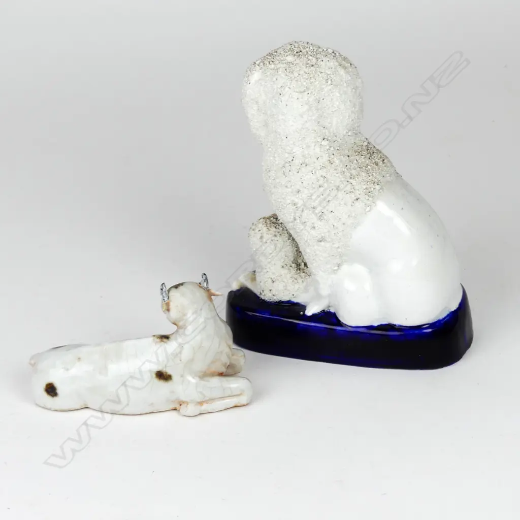 A Victorian Staffordshire dog group ornament and similar recumbent cow Image 1++