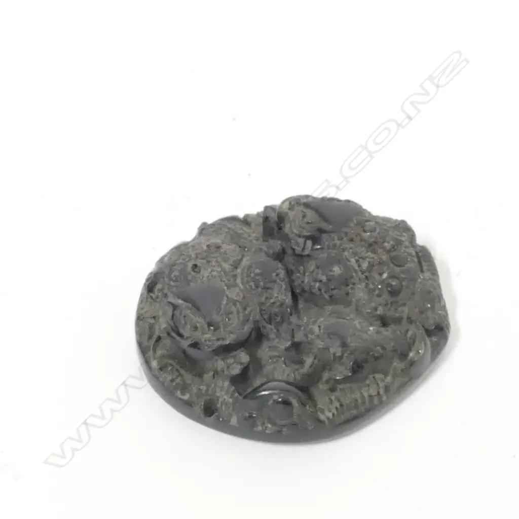 A Chinese black stone disc pendant Image 1++