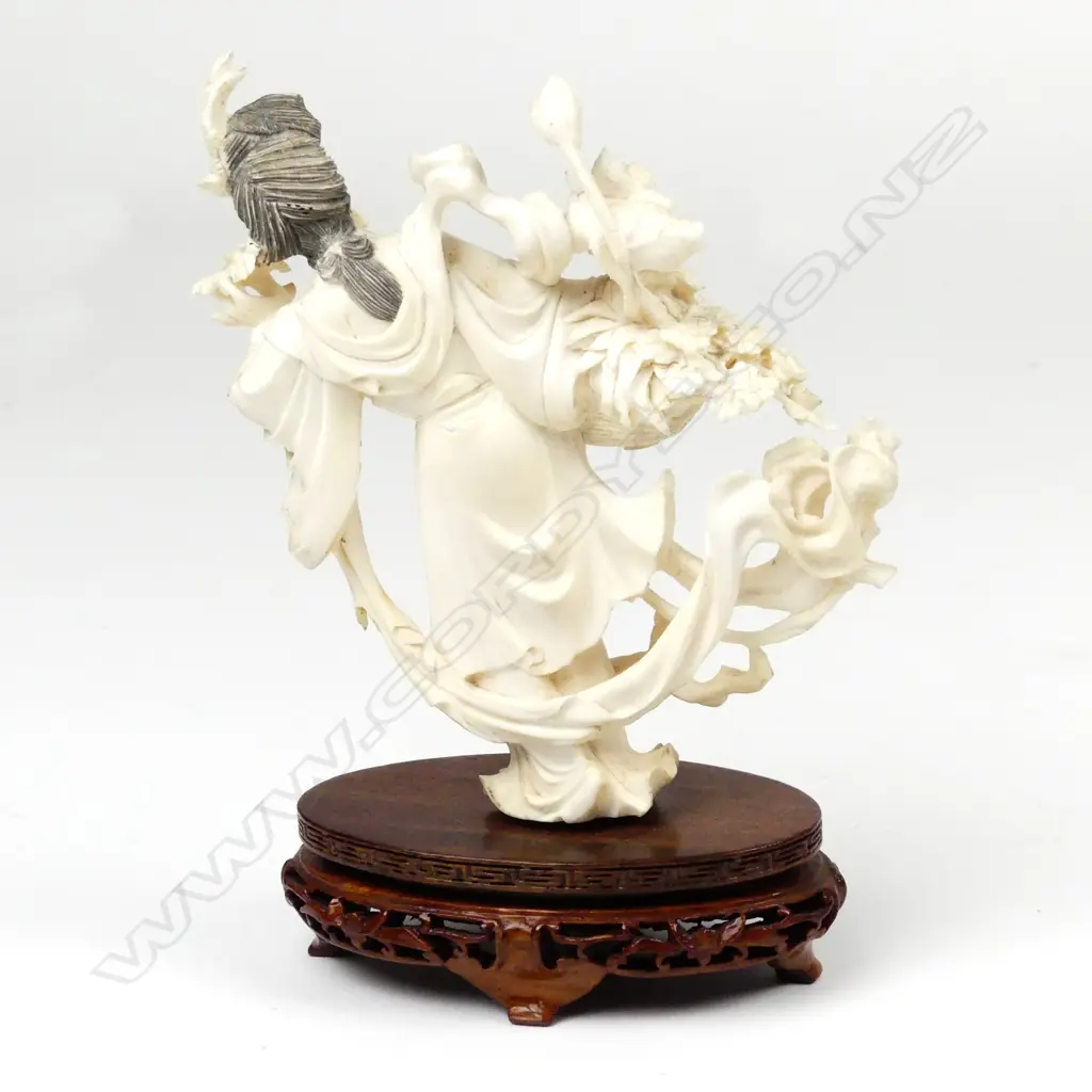 A Chinese ivory figure of a woman with basket of flowers Image 1++
