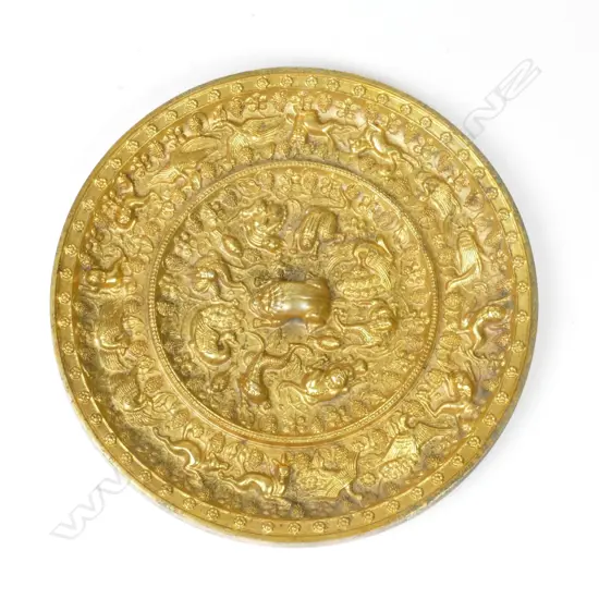 A highly ornate gilded Oriental bronze circular mirror