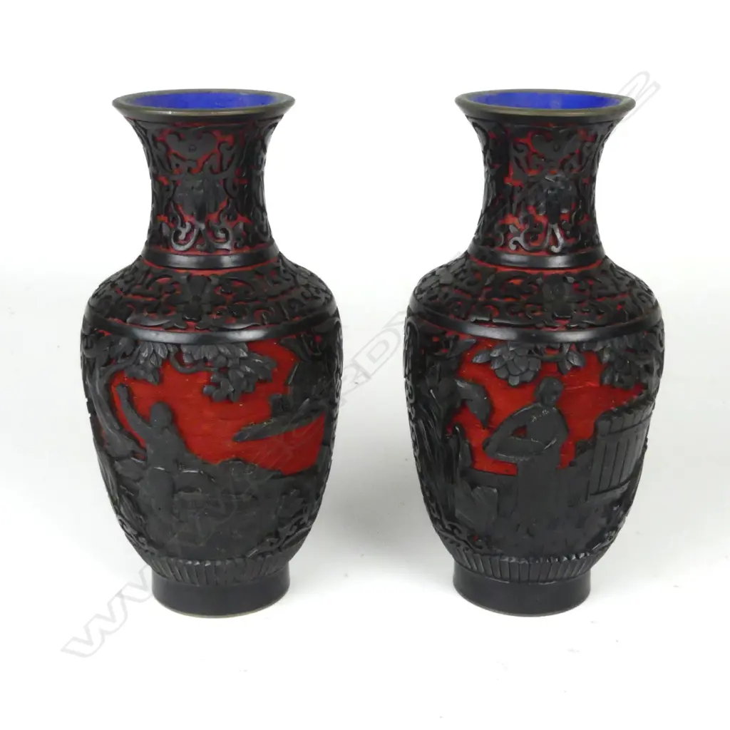 A pair of carved black lacquer over cinnabar vases Image 1++