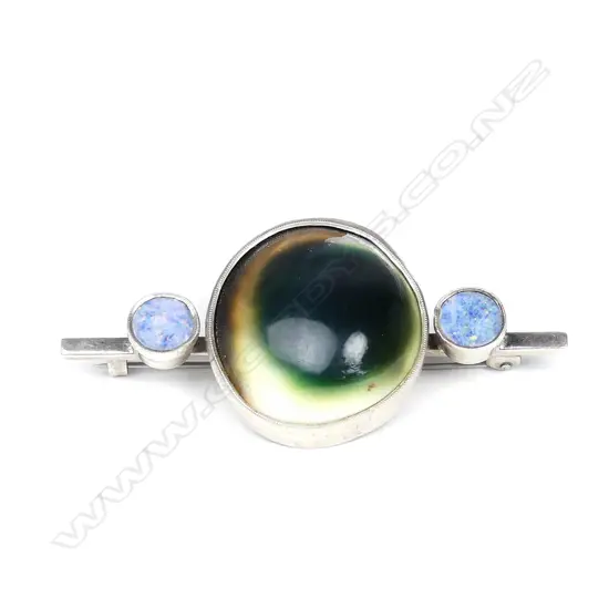 A silver and cats eye brooch