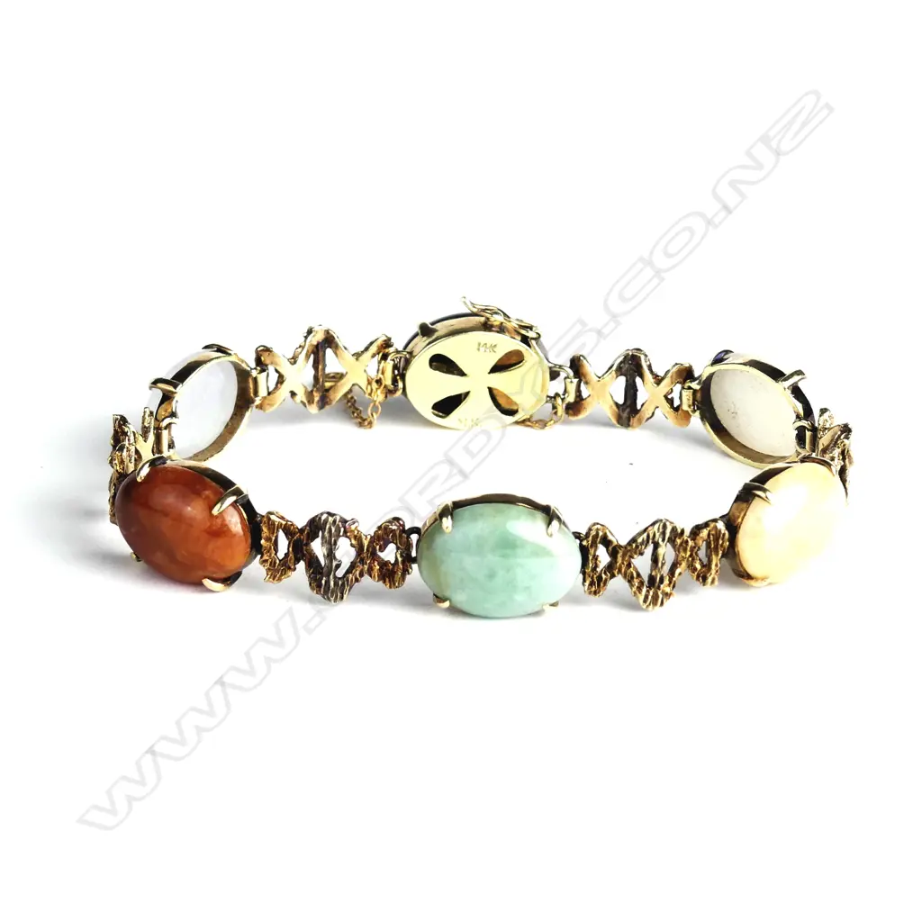 A stylish vintage 14ct. yellow gold and variously coloured jade cabochon bracelet Image 1++