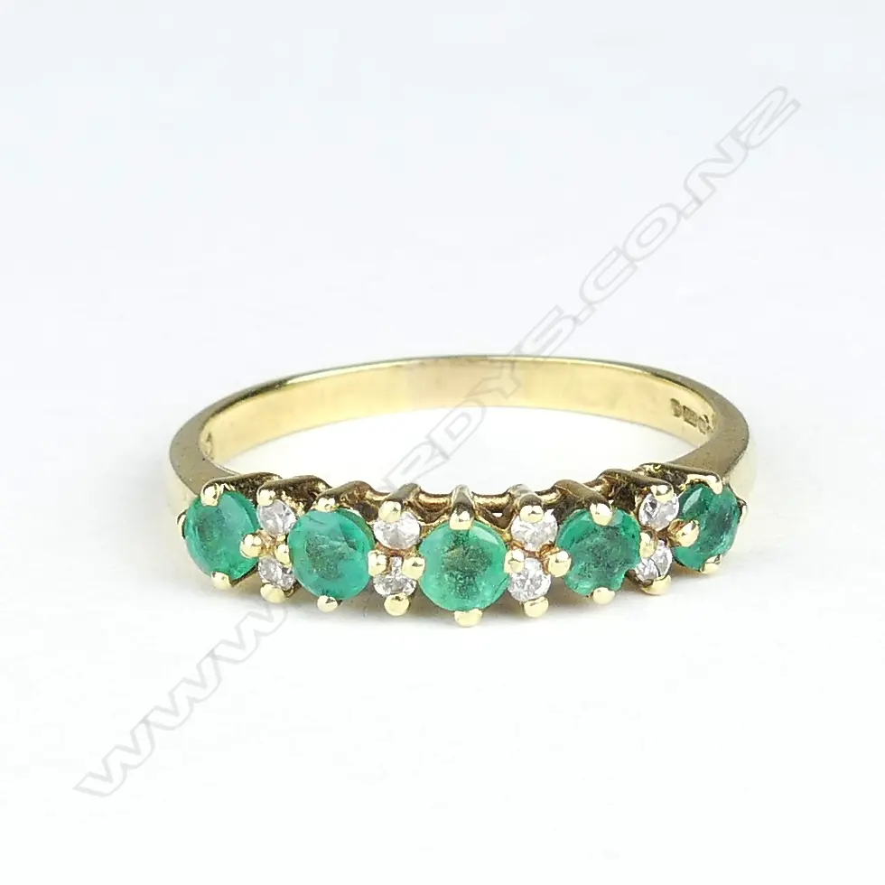 An 18ct gold emerald and diamond ring Image 1++