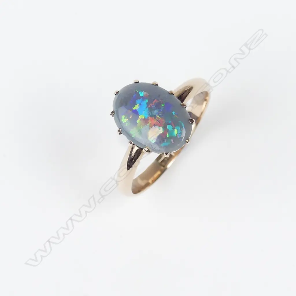 A 9ct rose gold and black opal ring Image 1++