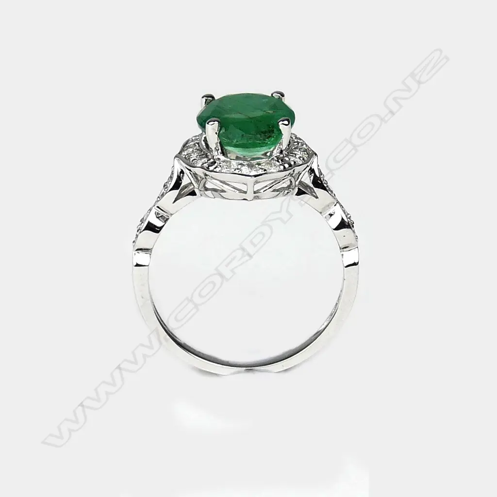 A 14ct white gold emerald and diamond ring Image 1++